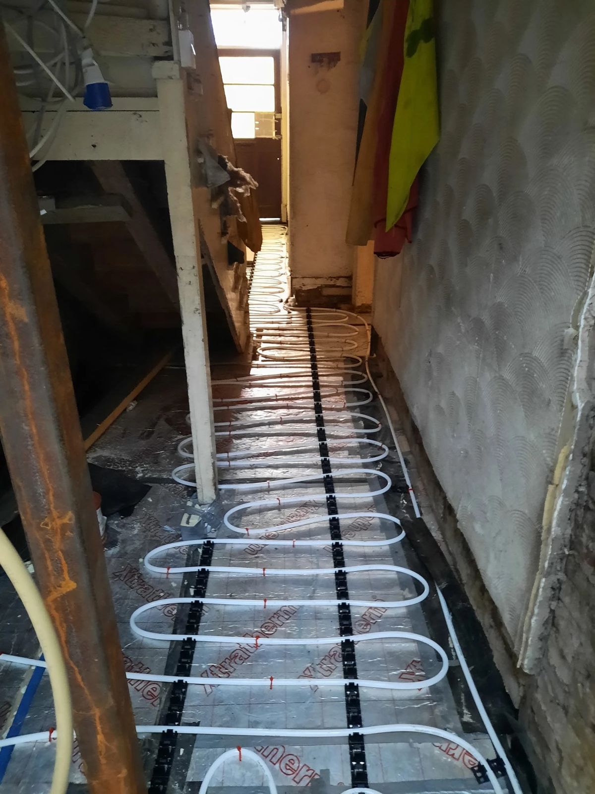 Underfloor heating pipework laid in a hallway
